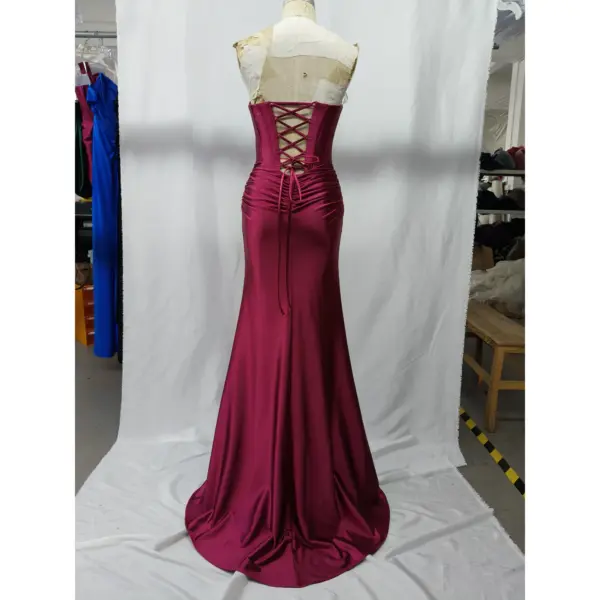 Back view of Alex Burgundy stretch satin mermaid gown showcasing dramatic lace-up corset back with intricate criss-cross detailing, ruched hips, and sweeping train