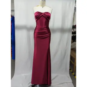 Stunning strapless sweetheart neckline Burgundy stretch satin mermaid gown by Alex featuring ruched bodice, internal boning, and dramatic high slit on a mannequin in a studio setting