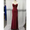 Stunning burgundy jersey mermaid gown with intricate lace appliqué and hotfix rhinestones on a sweetheart neckline, ruched hips, and dramatic high slit, displayed on a mannequin in a studio setting.