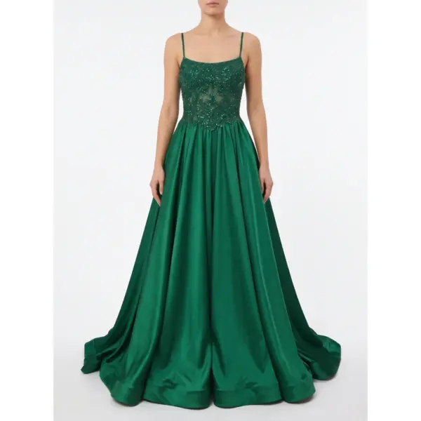 Stunning model wearing the Barbara Hunter Green stretch satin ball gown featuring a square neckline with delicate spaghetti straps, heavily beaded and embroidered sheer bodice with intricate lace appliqué, and a voluminous flowing A-line skirt that cascades dramatically to the floor.
