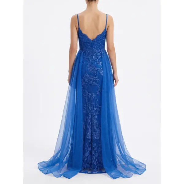 Back view of the Anne Royal Blue Embroidered Tulle A-Line Gown showcasing a deep V-back with delicate spaghetti straps, exquisite beaded floral lace appliques cascading down the fitted bodice and skirt, and a dramatic layered tulle overskirt with sweep train for regal elegance.